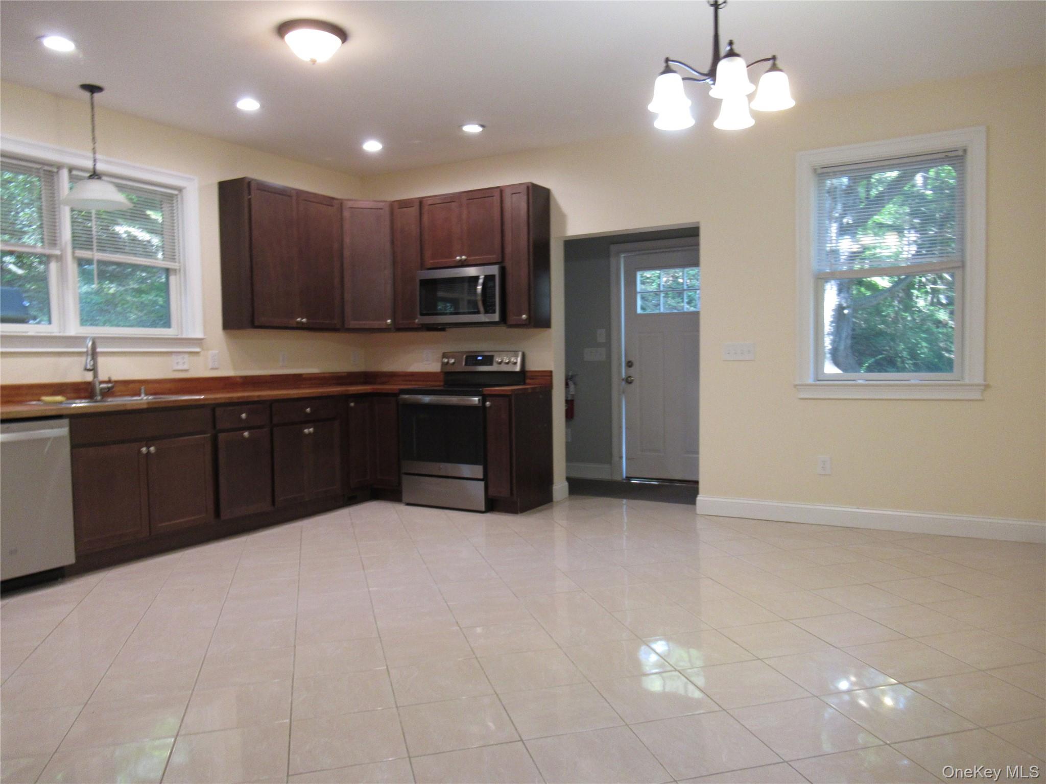 101 Bundy Hill Road Holmes, NY 12531 - Photo 3 of 28 a large kitchen with cabinets a sink and stainless steel appliances