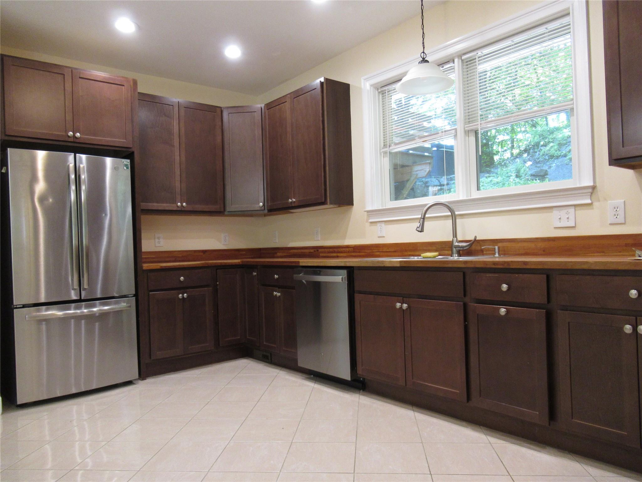 101 Bundy Hill Road Holmes, NY 12531 - Photo 4 of 28 a kitchen with stainless steel appliances granite countertop a sink refrigerator and microwave