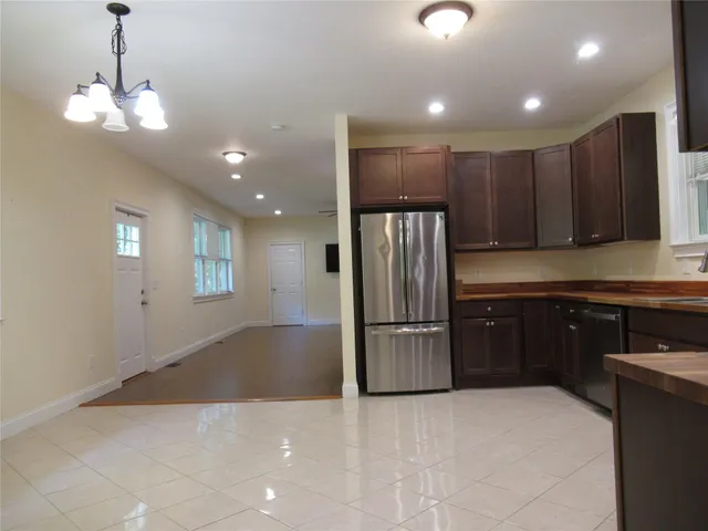 a kitchen with stainless steel appliances granite countertop a refrigerator and a sink