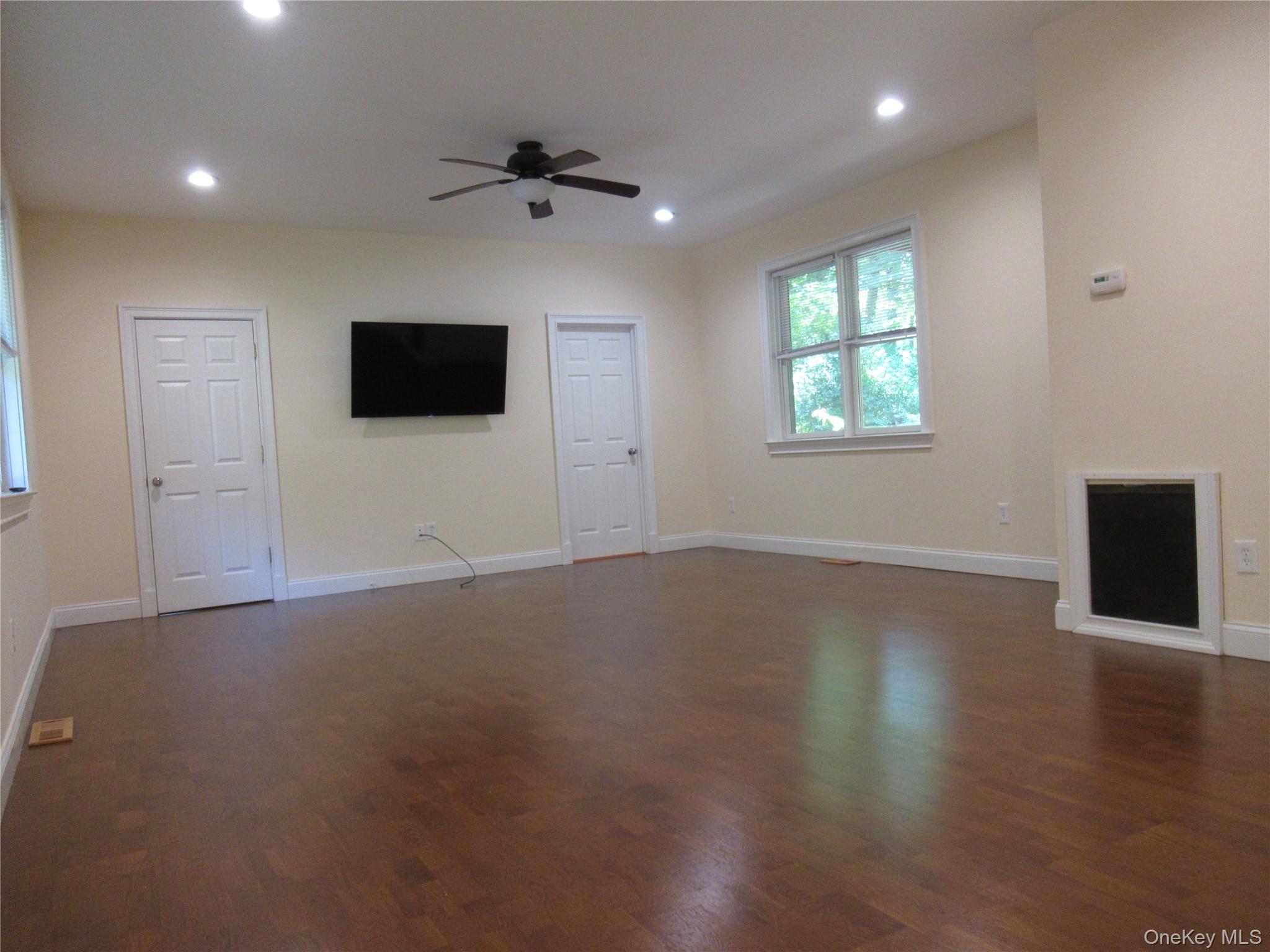 101 Bundy Hill Road Holmes, NY 12531 - Photo 6 of 28 an empty room with wooden floor and windows