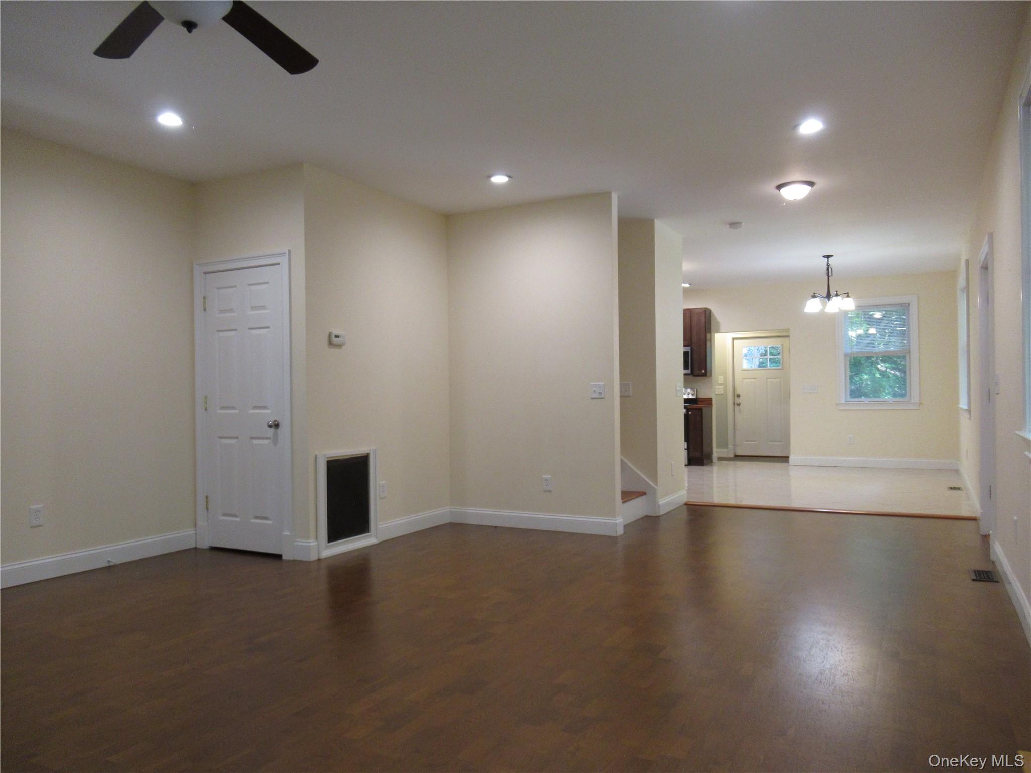 101 Bundy Hill Road Holmes, NY 12531 - Photo 7 of 28 wooden floor in an empty room with a kitchen