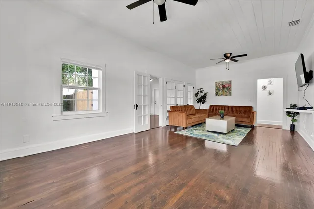 a living room with furniture and a wooden floor