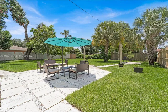 a view of backyard with sitting area