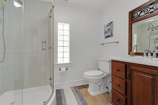 a bathroom with a sink toilet vanity and shower