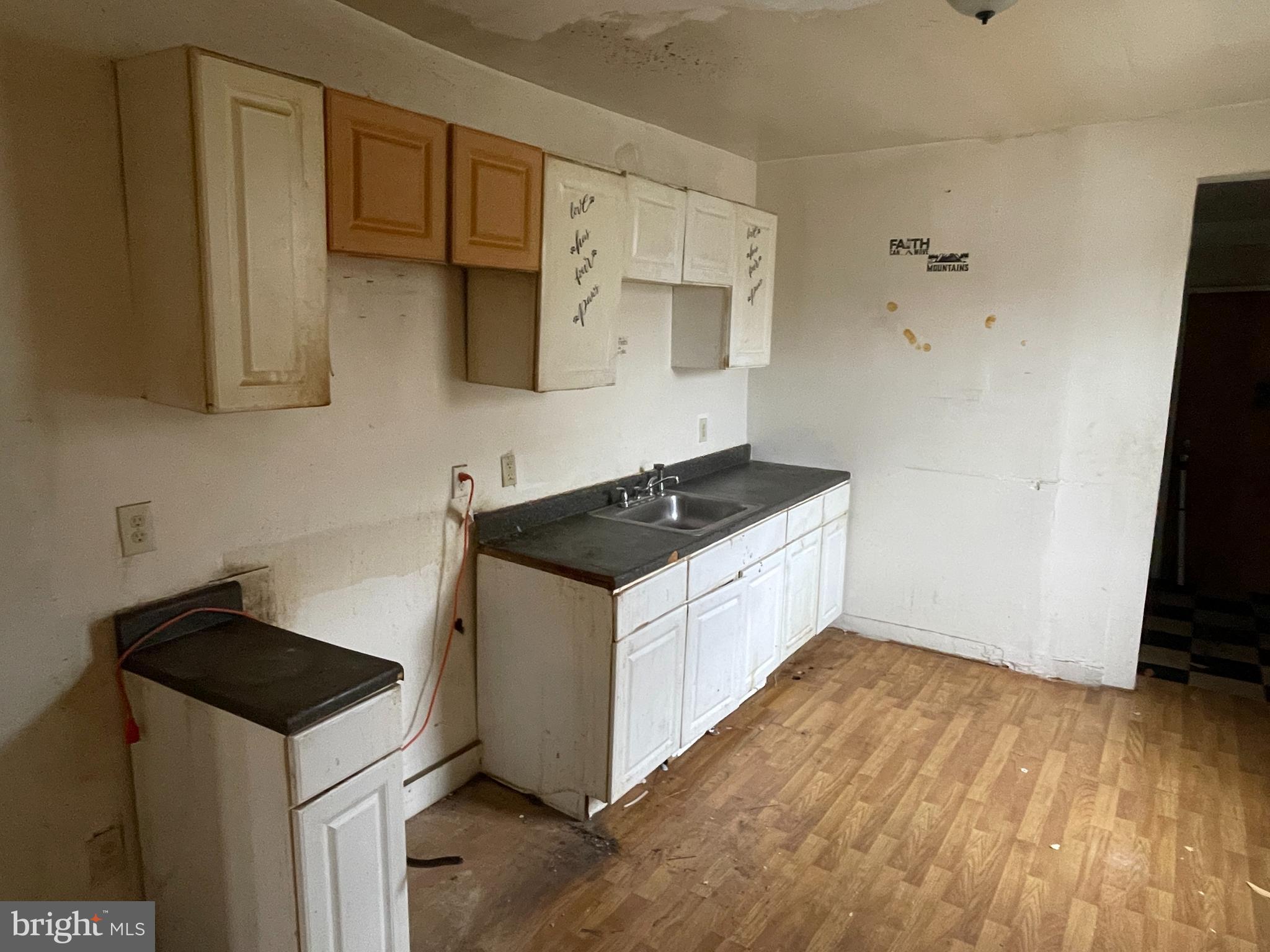 1822 Aiken Street Baltimore, MD 21213 - Photo 7 of 22 a kitchen with granite countertop a sink and a stove top oven