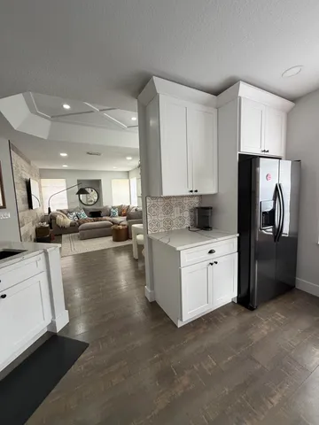 a kitchen with a refrigerator and a sink
