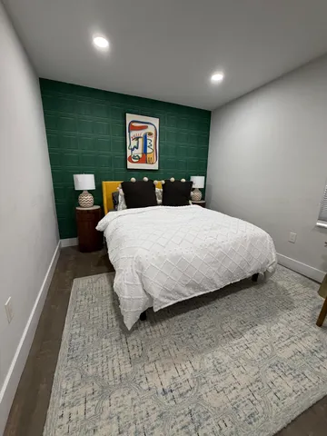 a bedroom with a bed and a dresser