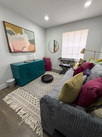 a bedroom with two bed and a window