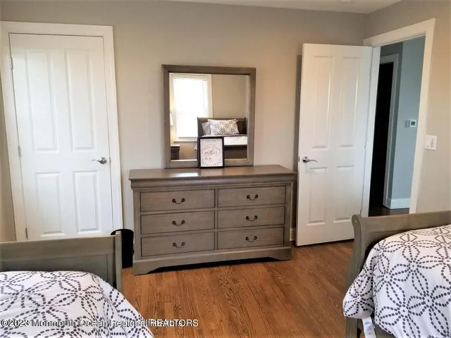 a bedroom with a bed and a dresser in it