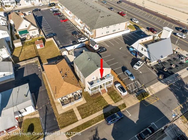 an aerial view of a house with pool and outdoor seating