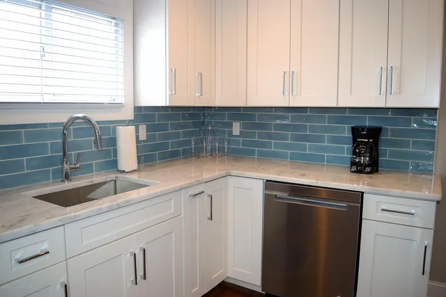 a kitchen with a sink and cabinets
