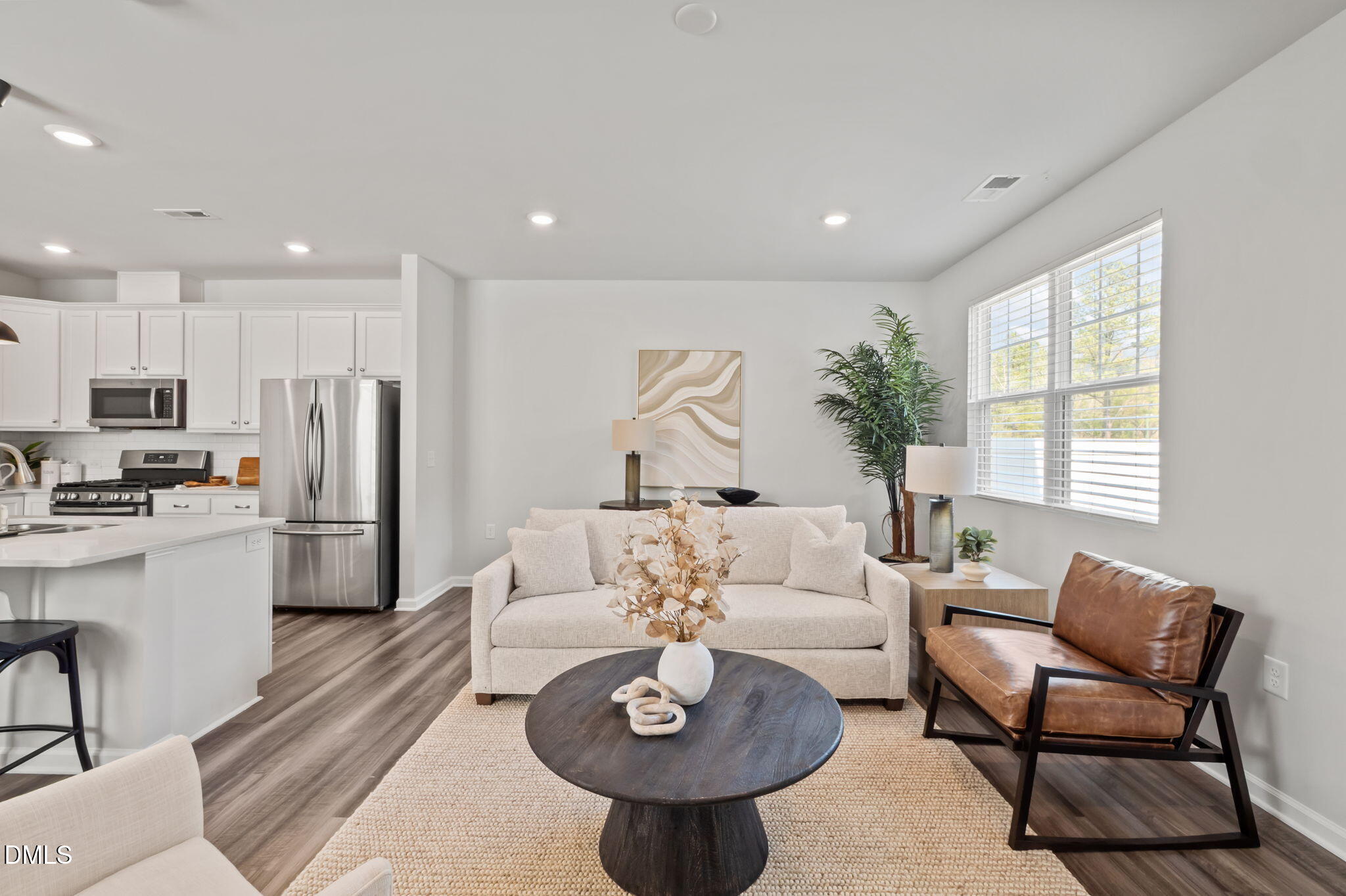 1050 Gentle Reed Drive Durham, NC 27703 - Photo 11 of 37 a living room with stainless steel appliances furniture a rug and a kitchen