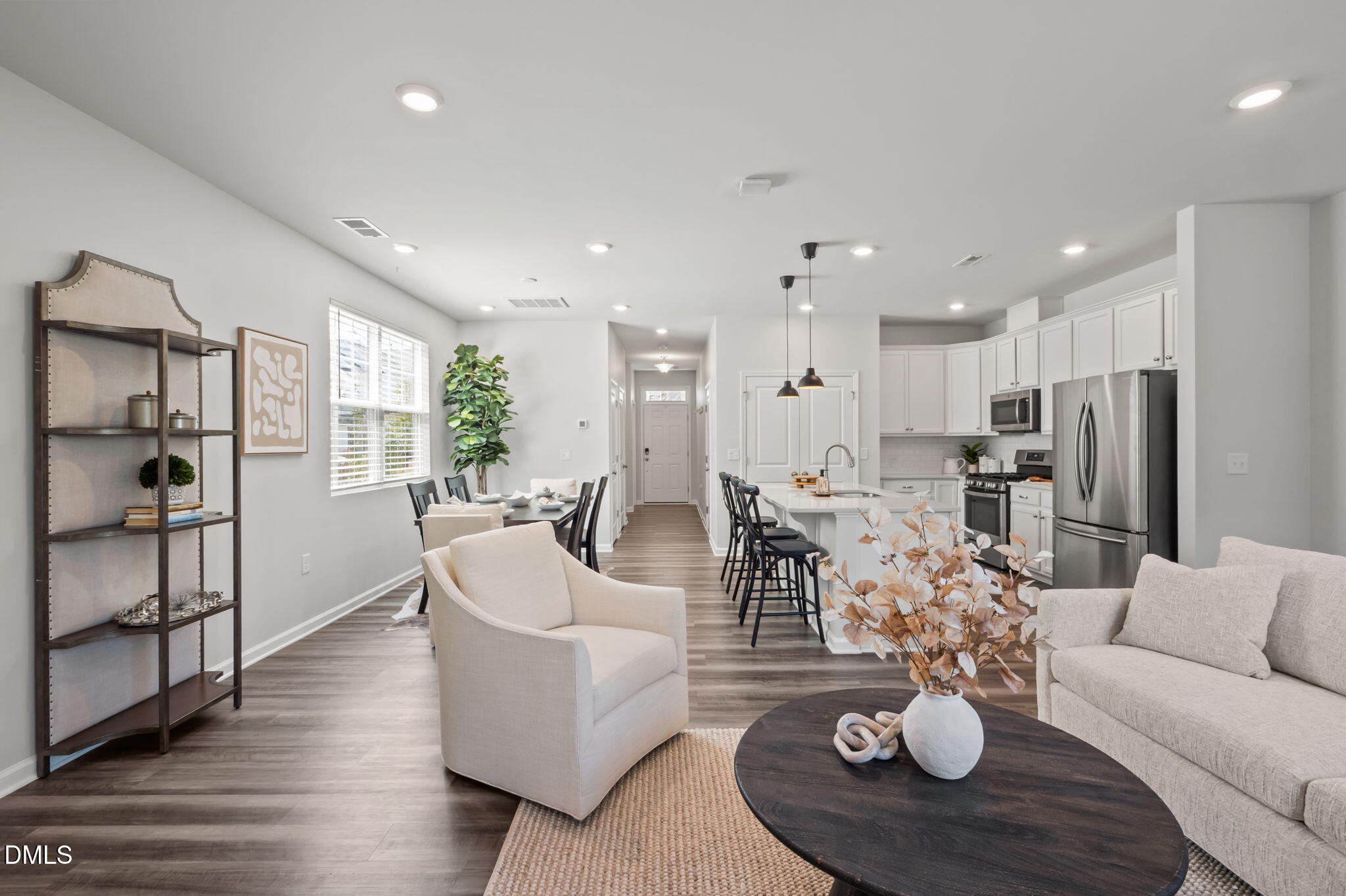 1050 Gentle Reed Drive Durham, NC 27703 - Photo 12 of 37 a living room with furniture kitchen view and a wooden floor