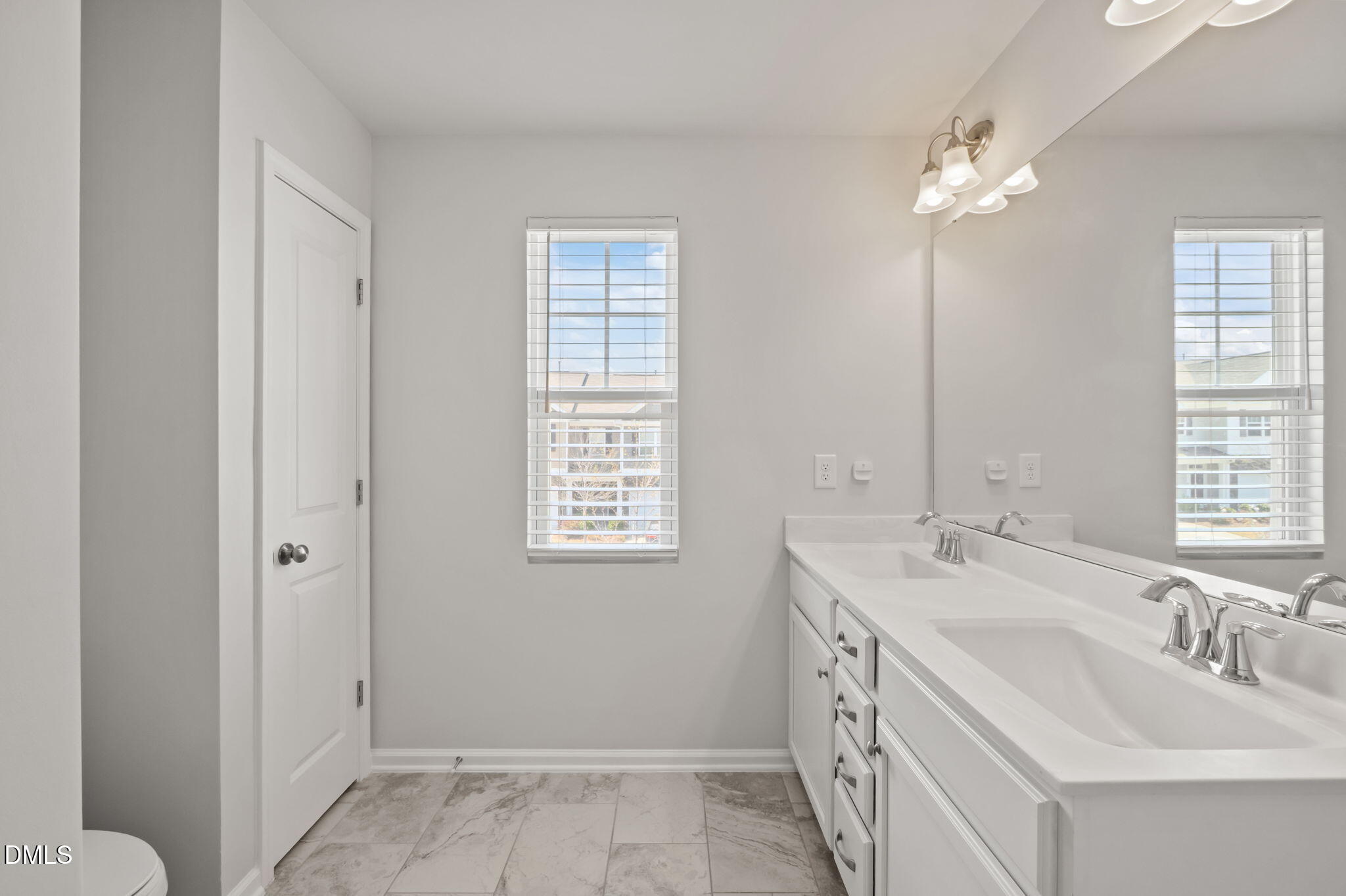 1050 Gentle Reed Drive Durham, NC 27703 - Photo 18 of 37 a bathroom with double vanity and a mirror