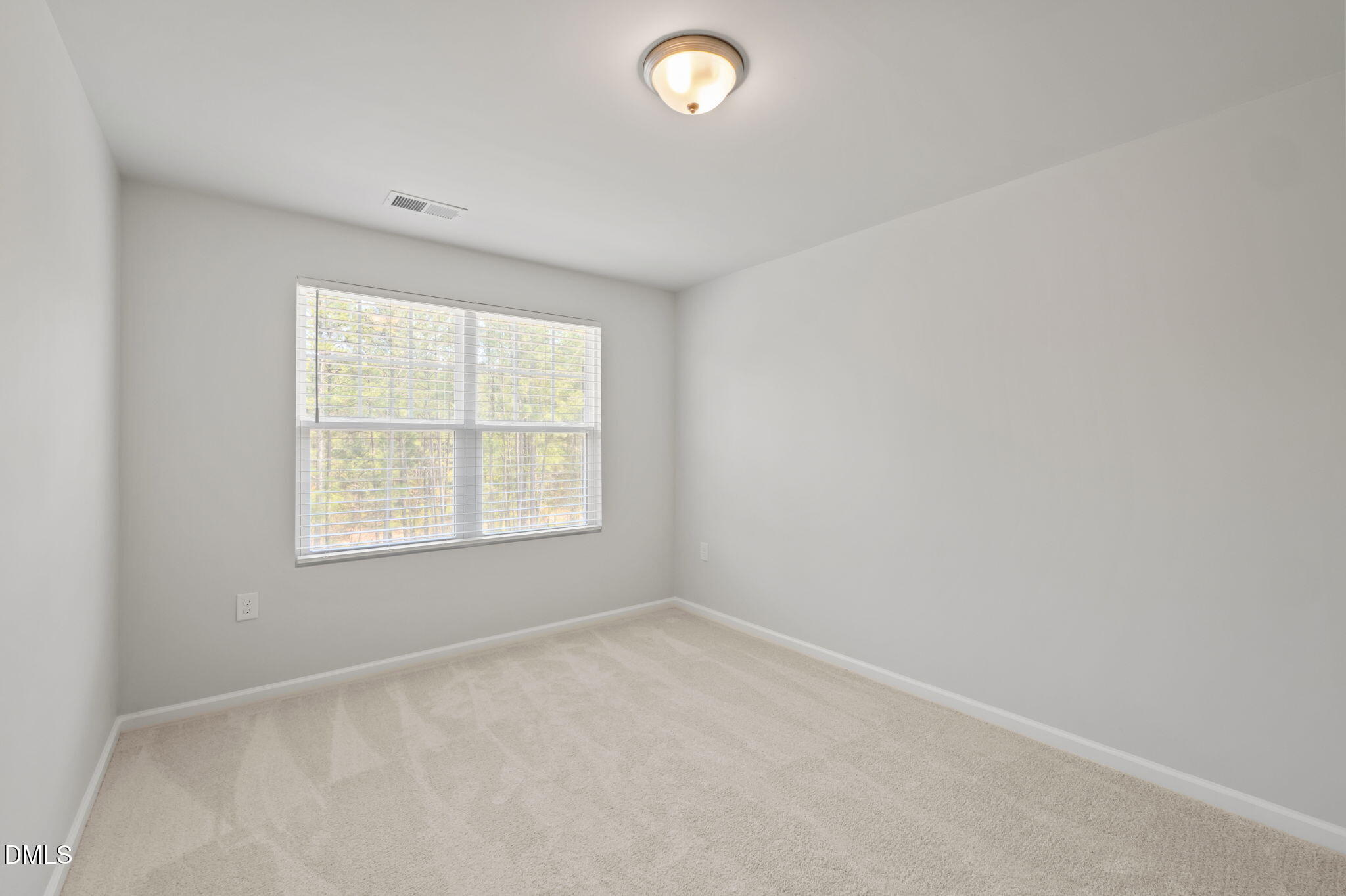 1050 Gentle Reed Drive Durham, NC 27703 - Photo 23 of 37 an empty room with a window