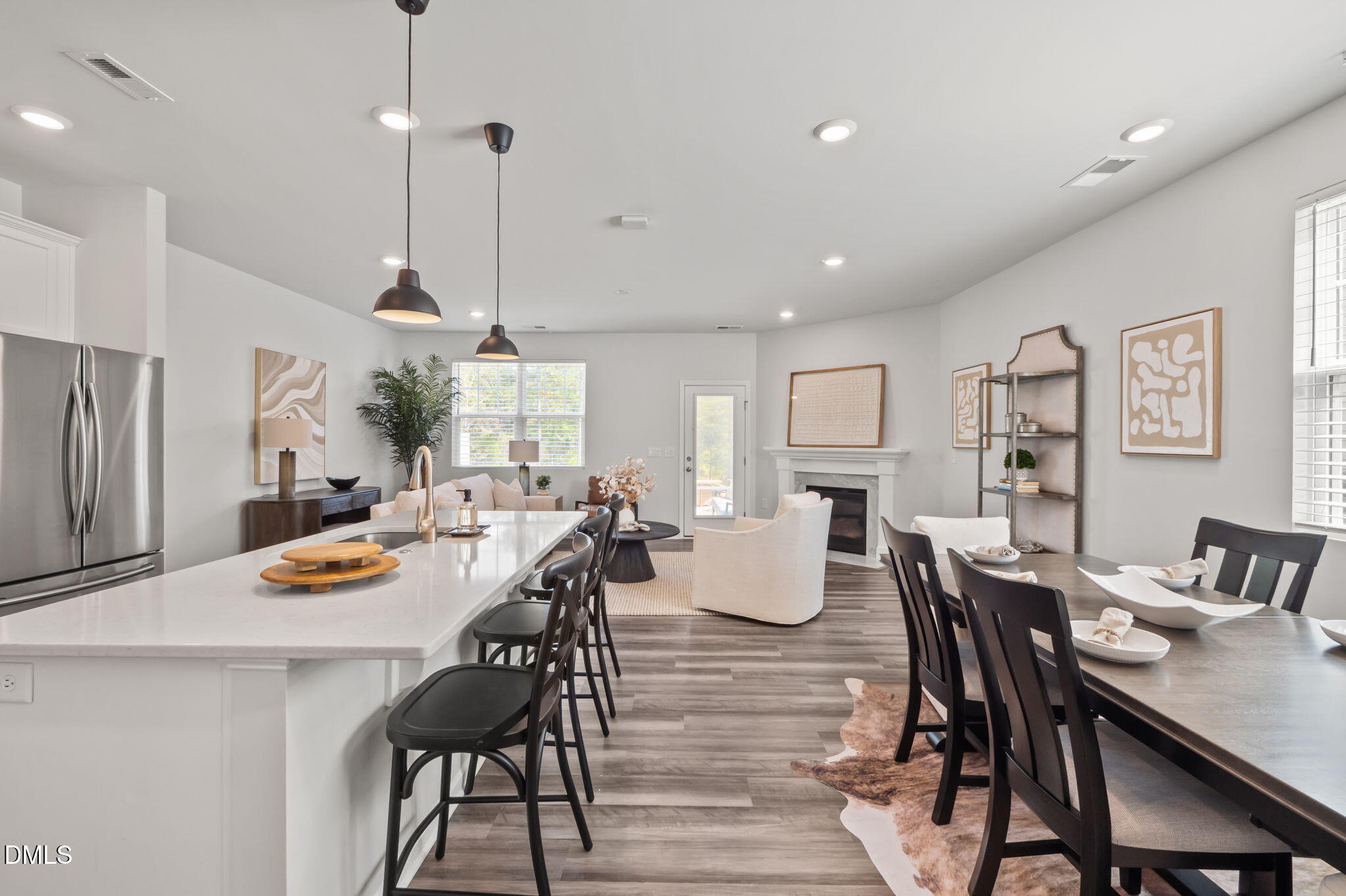 1050 Gentle Reed Drive Durham, NC 27703 - Photo 5 of 37 a dining room with wooden floor a chandelier a wooden table and chairs