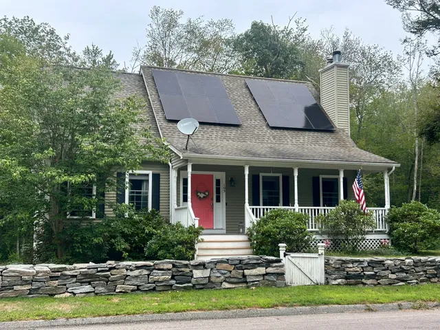 a front view of a house with a yard garage and outdoor seating