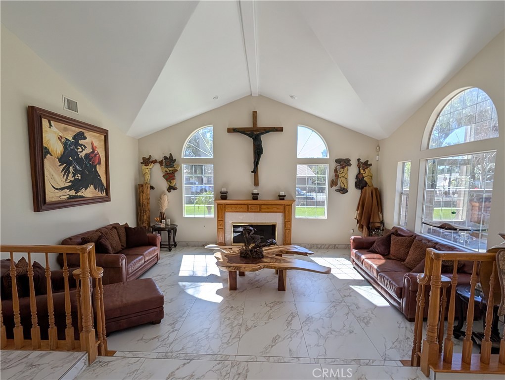 1719 Crystal Ridge Court Riverside, CA 92506 - Photo 13 of 60 a living room with furniture a fireplace and a large window