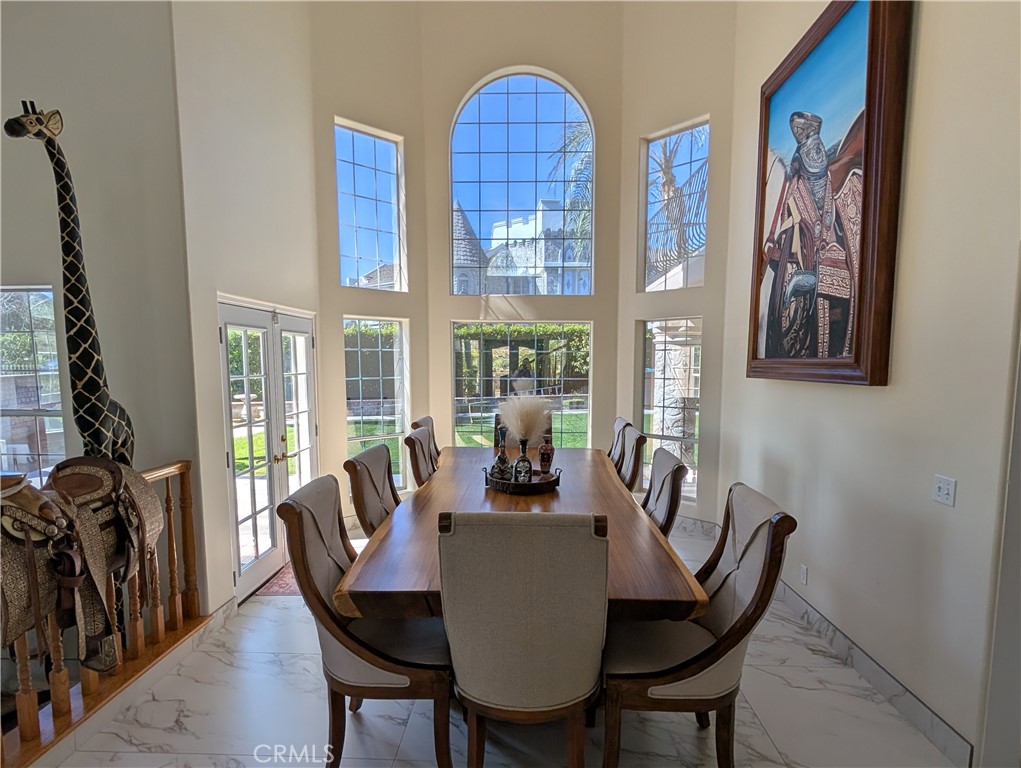 1719 Crystal Ridge Court Riverside, CA 92506 - Photo 14 of 60 a dining room with furniture a rug and a large window