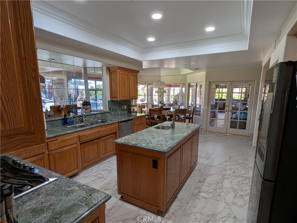 1719 Crystal Ridge Court Riverside, CA 92506 - Photo 15 of 60 a kitchen with stainless steel appliances granite countertop a stove a sink and a refrigerator