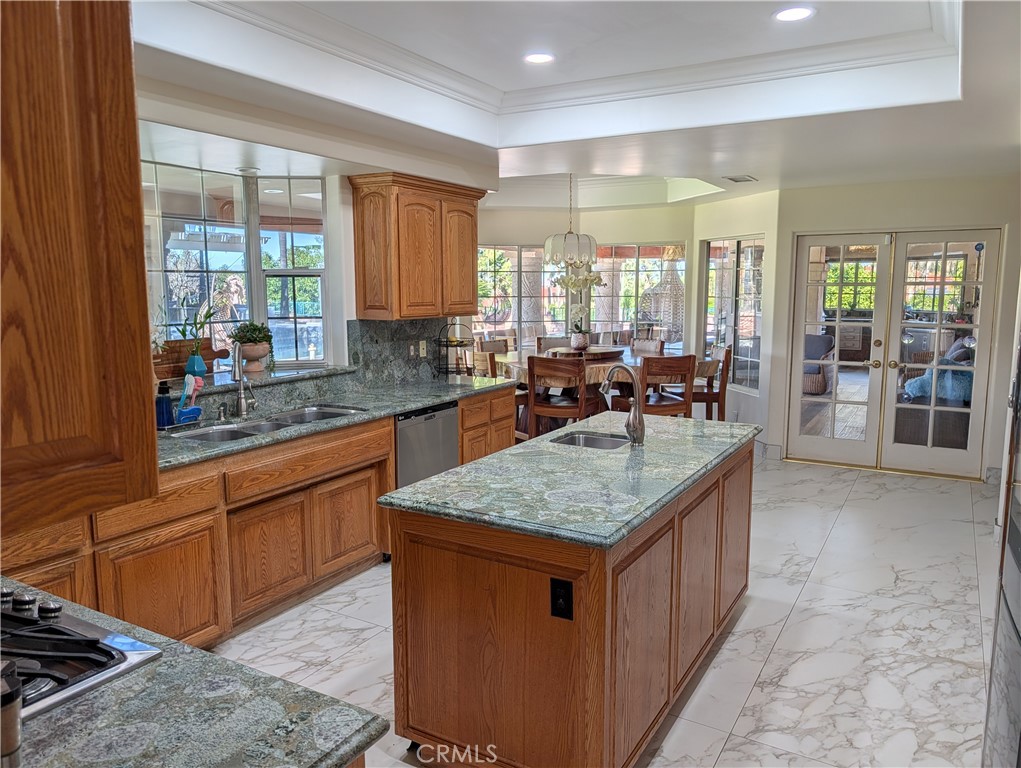 1719 Crystal Ridge Court Riverside, CA 92506 - Photo 16 of 60 a kitchen with stainless steel appliances granite countertop a stove a sink and a microwave
