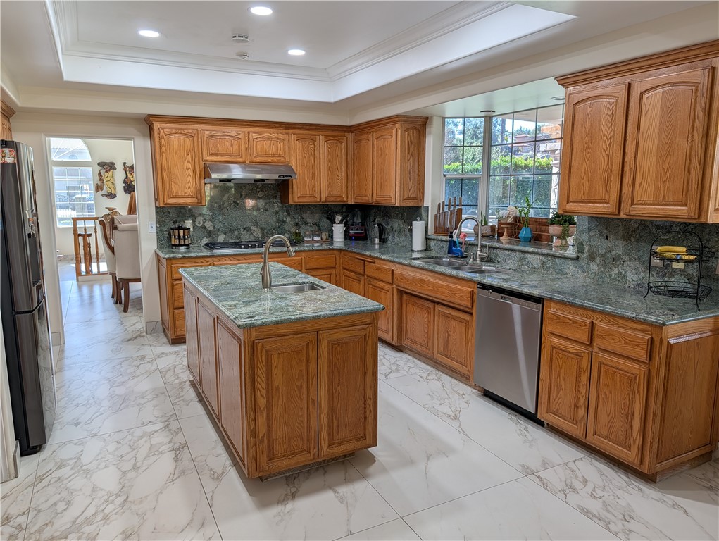 1719 Crystal Ridge Court Riverside, CA 92506 - Photo 17 of 60 a kitchen with stainless steel appliances granite countertop a stove a sink dishwasher and a refrigerator