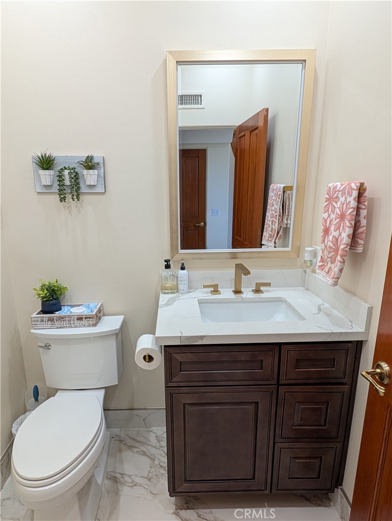 1719 Crystal Ridge Court Riverside, CA 92506 - Photo 23 of 60 a bathroom with a toilet a sink and mirror