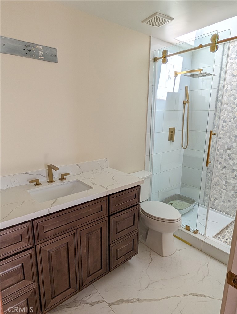 1719 Crystal Ridge Court Riverside, CA 92506 - Photo 25 of 60 a bathroom with a sink a toilet and shower