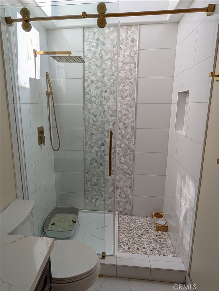 1719 Crystal Ridge Court Riverside, CA 92506 - Photo 26 of 60 a bathroom with a shower toilet and sink