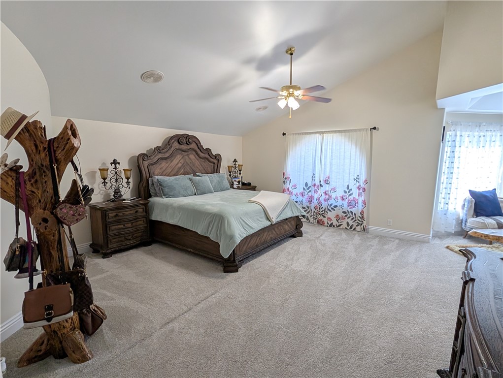 1719 Crystal Ridge Court Riverside, CA 92506 - Photo 29 of 60 a spacious bedroom with a bed and a chandelier