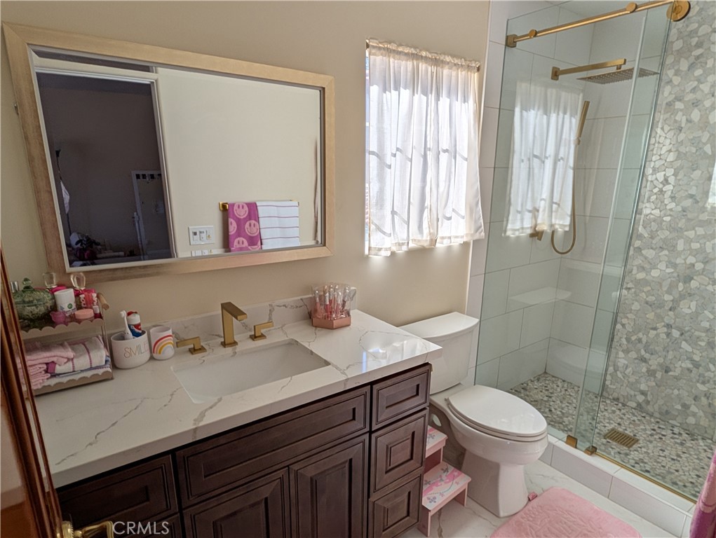 1719 Crystal Ridge Court Riverside, CA 92506 - Photo 39 of 60 a bathroom with a sink a toilet and shower