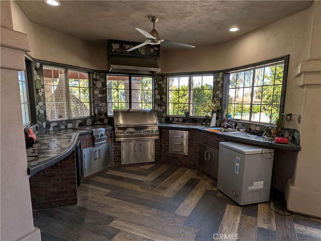 1719 Crystal Ridge Court Riverside, CA 92506 - Photo 46 of 60 a kitchen with a sink appliances cabinets and a large window