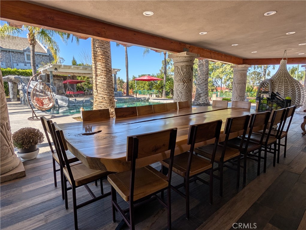 1719 Crystal Ridge Court Riverside, CA 92506 - Photo 47 of 60 a view of a dining room with furniture large windows and wooden floor
