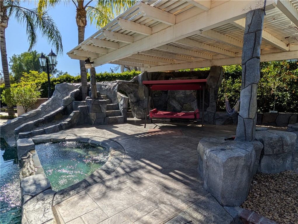 1719 Crystal Ridge Court Riverside, CA 92506 - Photo 60 of 60 a view of a patio with table and chairs under an umbrella