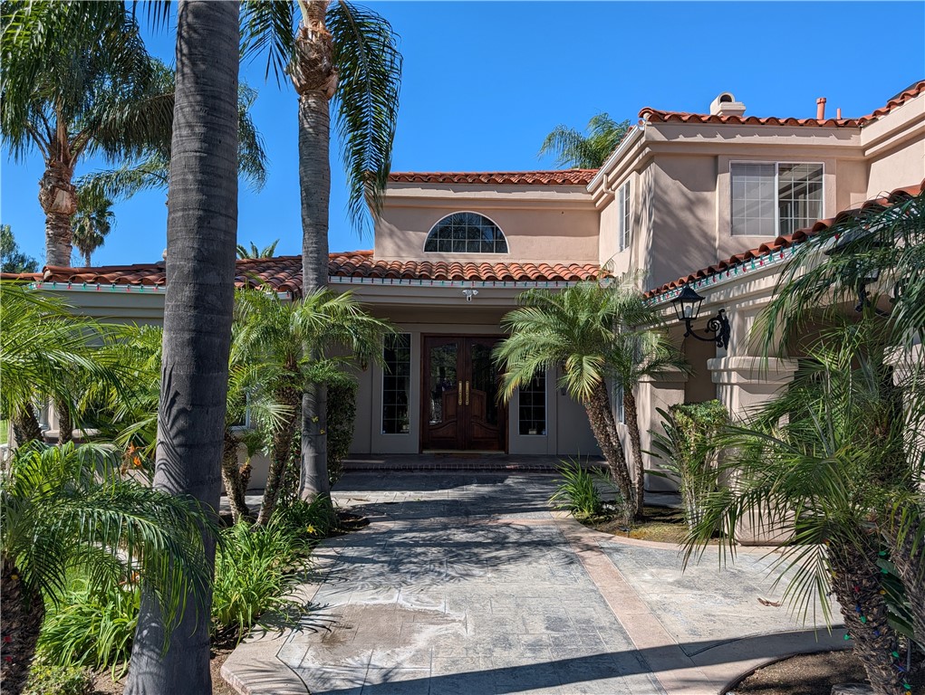 1719 Crystal Ridge Court Riverside, CA 92506 - Photo 7 of 60 a front view of a house with plants and a tree