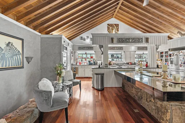 a kitchen with furniture and wooden floor