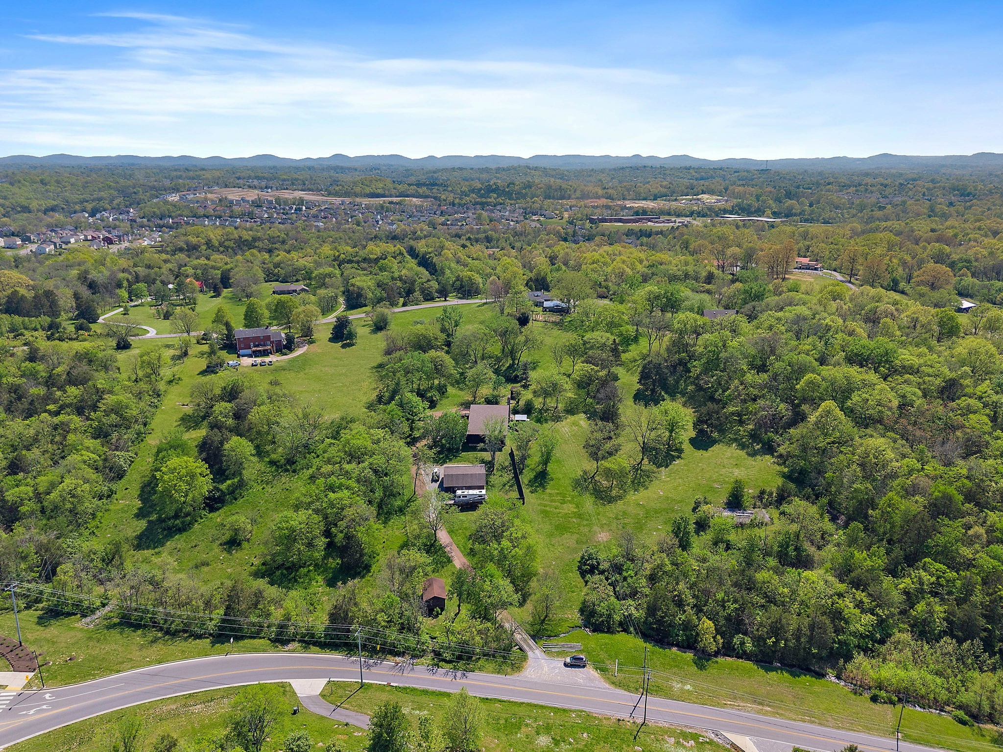 5521 Cane Ridge Road Antioch, TN 37013 - Photo 26 of 32 an aerial view of green landscape with trees houses and mountain view
