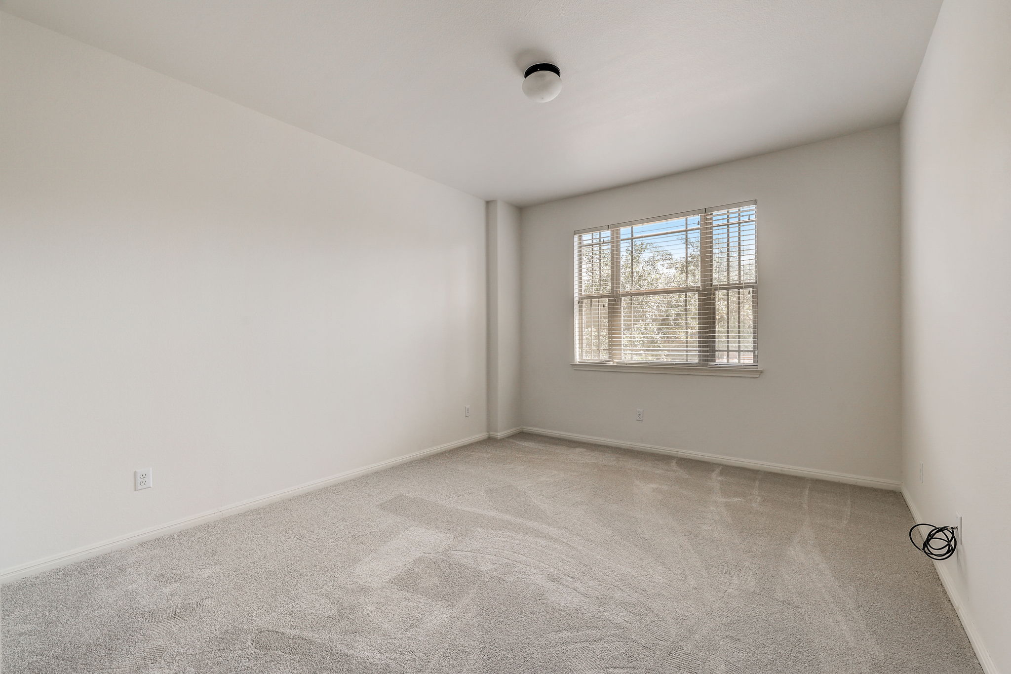 16012 Spillman Ranch Loop Austin, TX 78738 - Photo 28 of 38 A quiet space awaits, with soft carpet and a sun-filled window, offering a serene escape.