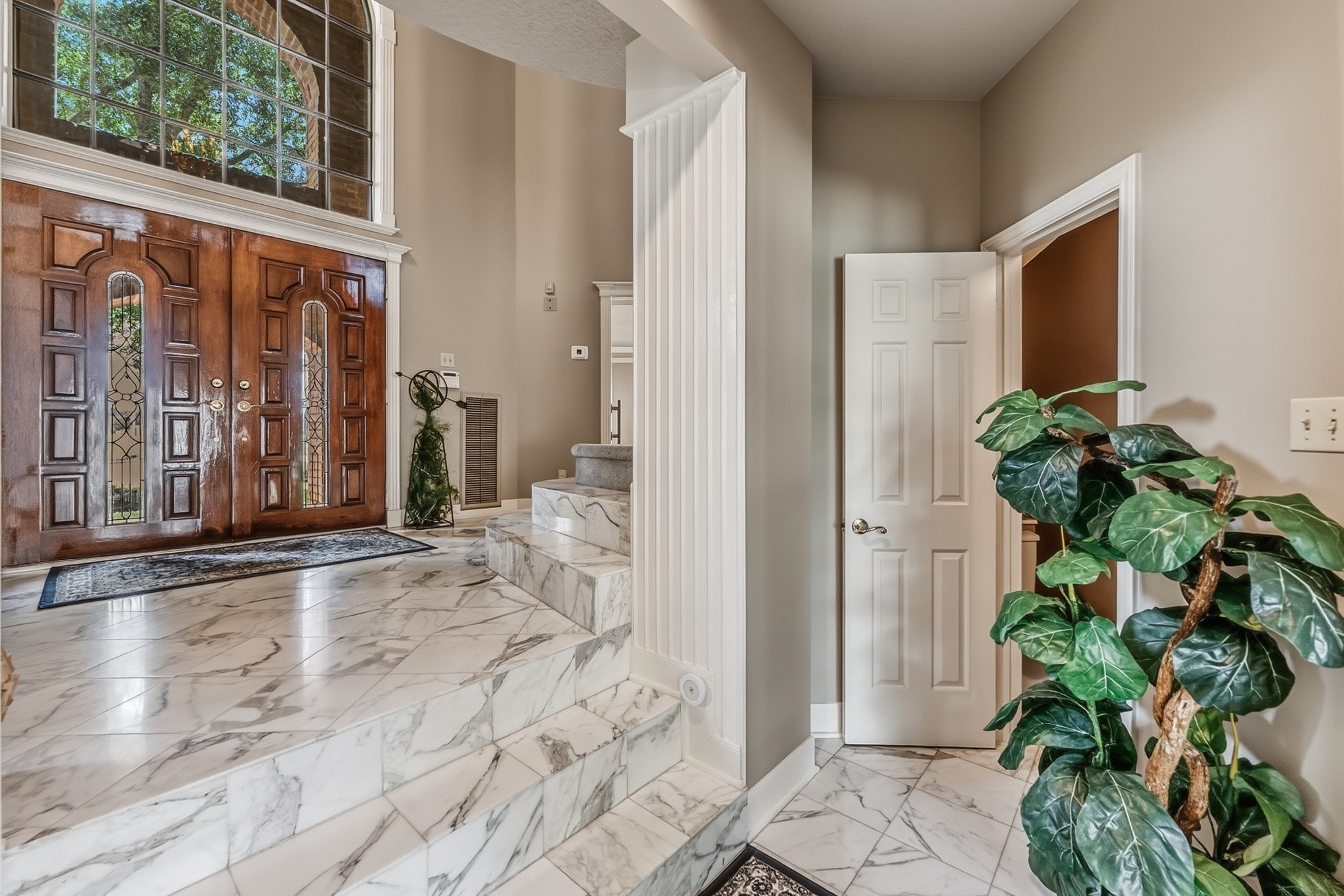 6047 Spring Creek Lane Spring, TX 77379 - Photo 6 of 50 Wrapped in rich stone finishes and positioned just off the sliding glass doors, the powder bath was thoughtfully placed for easy access from the patio and pool and living room. The warm palette and classic materials give the space a polished, understated feel.
