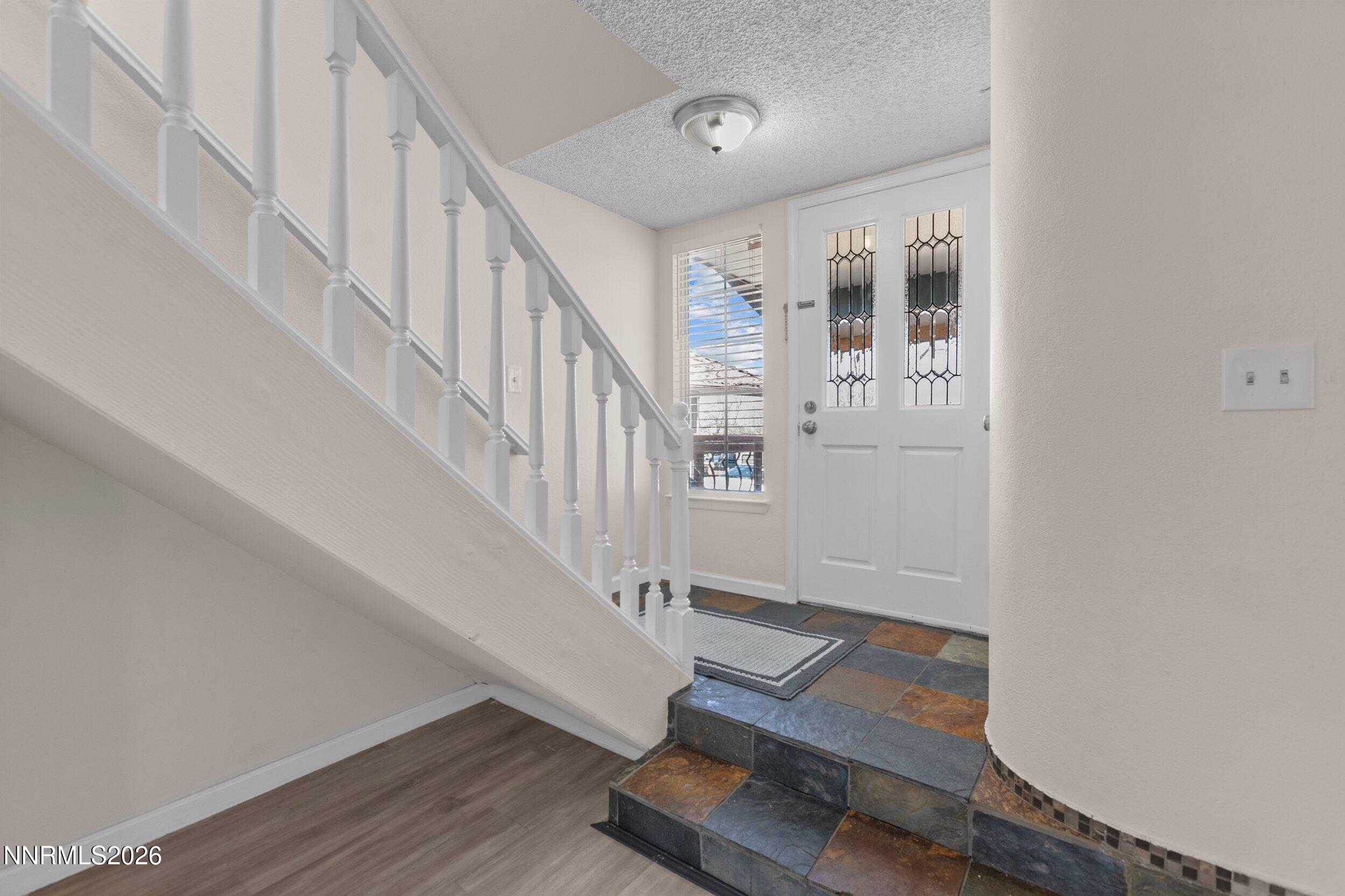 a view of entryway with wooden floor