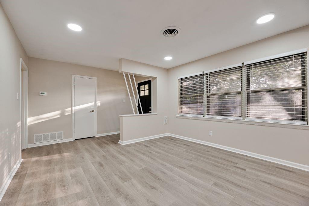 5706 Rocky Ridge Road Dallas, TX 75241 - Photo 2 of 31 an empty room with wooden floor and windows