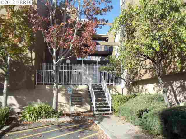 2121 Vale Road, Unit 319 San Pablo, CA 94806 - Photo 1 of 1 a front view of a house with trees