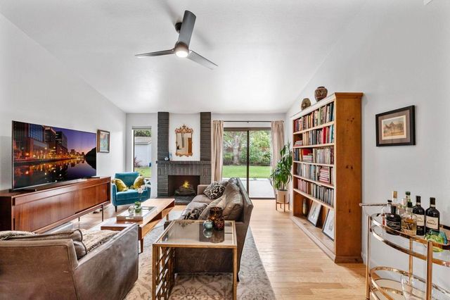 a living room with furniture a rug and a flat screen tv