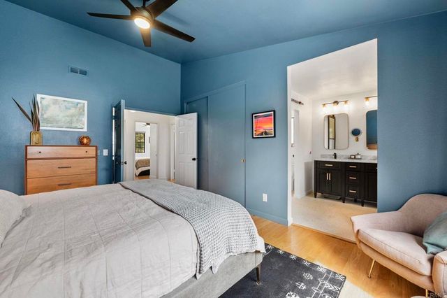 a bedroom with a bed and ceiling fan