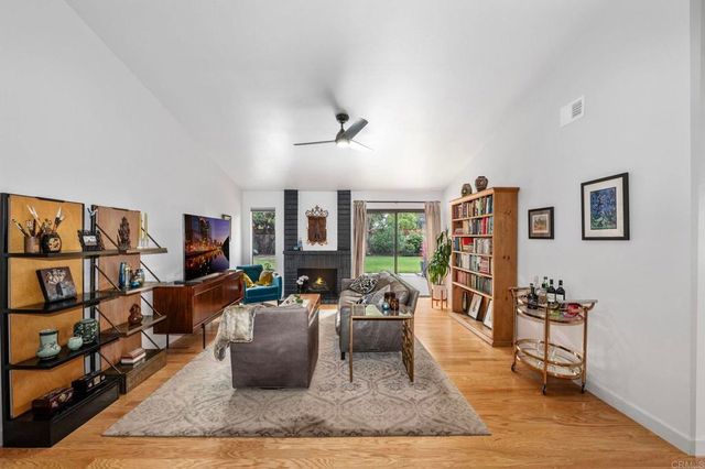 a living room with furniture and a book shelf