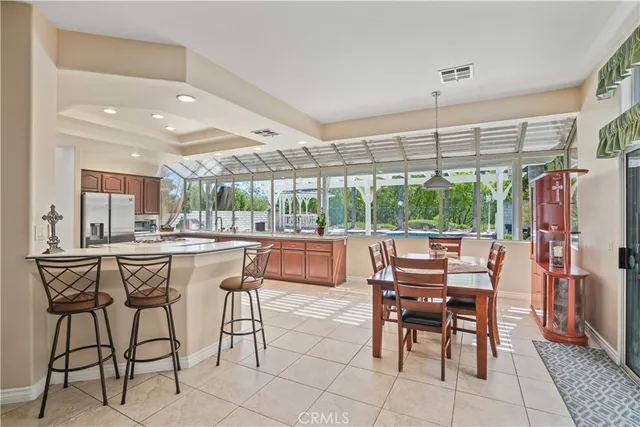 a dining hall with stainless steel appliances a table and chairs