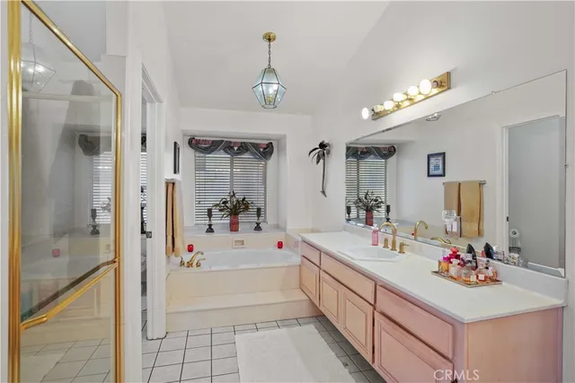 a bathroom with a sink a tub and a mirror