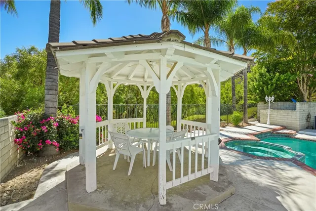 a view of a house with a porch and furniture
