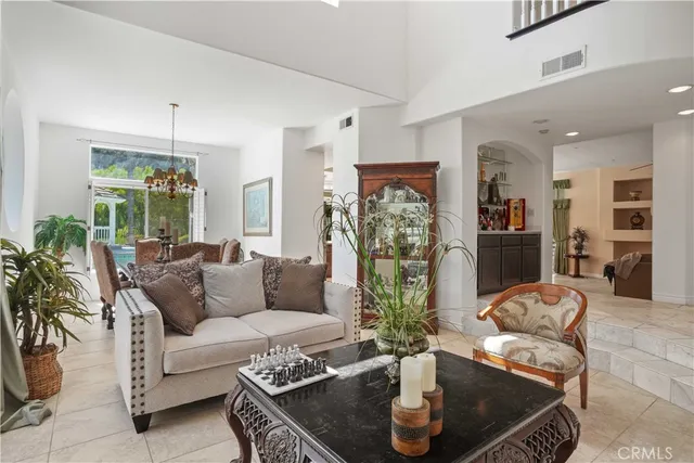 a living room with furniture and a chandelier