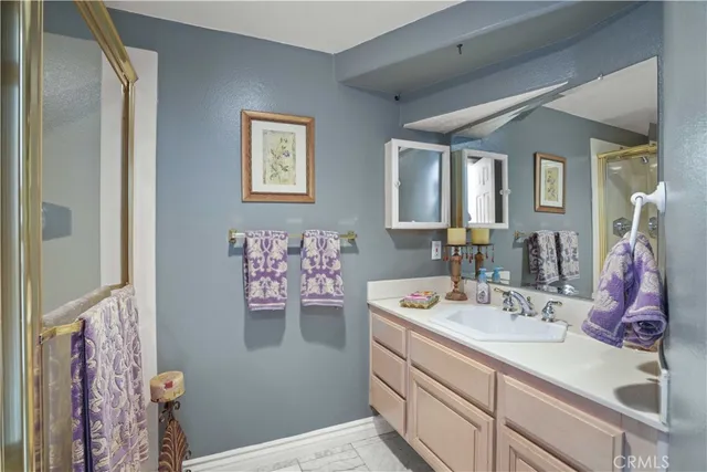 a bathroom with a sink mirror and vanity